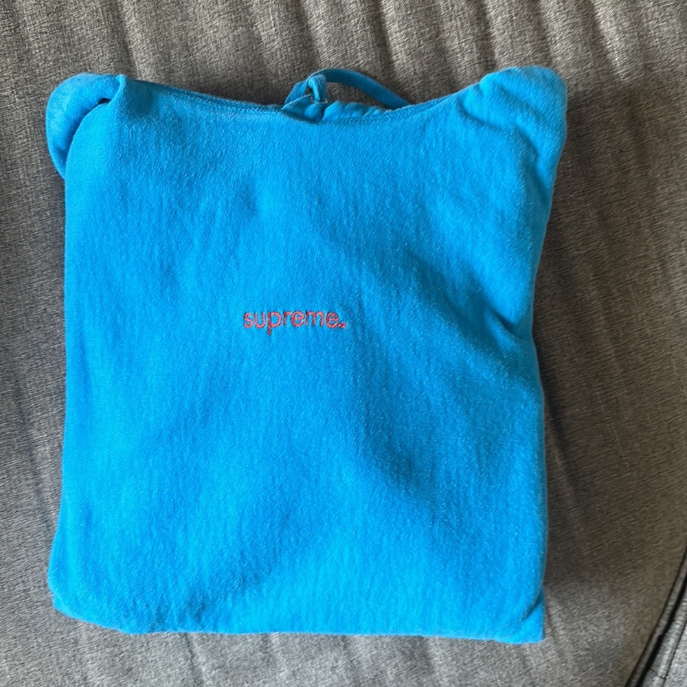 Supreme washed blue hoodie with orange embroidered logo